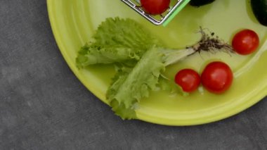 Vegetables, a plate and a shopping trolley against the background of an old rag