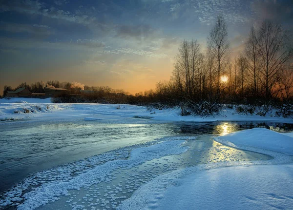 冬天森林里的落日 一条冰冷的河流流过 周围覆盖着一层雪 夜幕降临 夕阳西下 — 图库照片