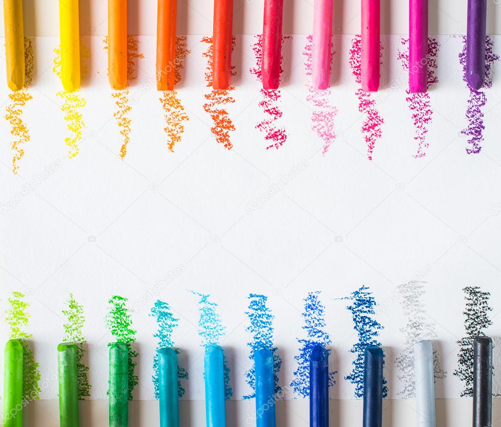 Colorful wax crayons with strokes