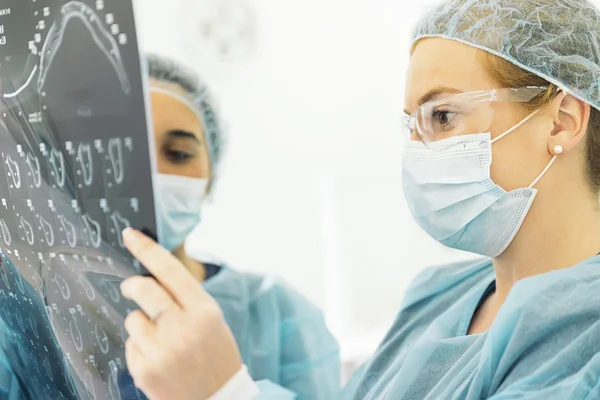 Showing something to her colleague on x-ray image. — Stock Photo, Image