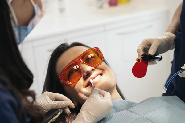 Dentyści z pacjentem podczas interwencji dentystycznych. — Zdjęcie stockowe