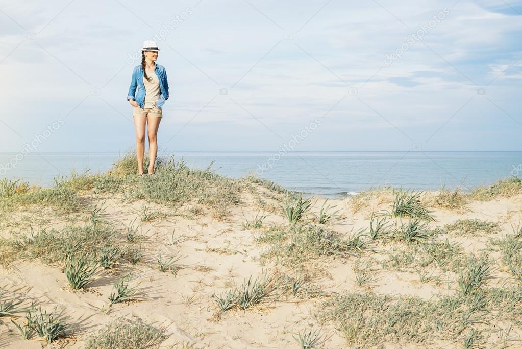 Woman walking away on the idylic beach.