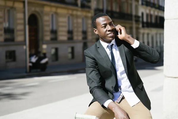 Homem africano com telefone celular e bicicleta . — Fotografia de Stock