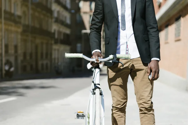Handsome african man on bike in the city. — Stock Photo, Image