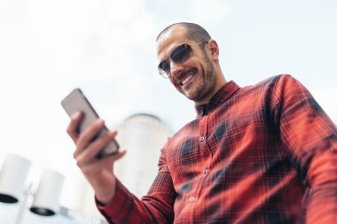 Genç adam sokakta cep telefonunu kullanma.