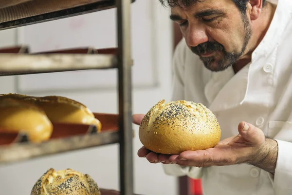 Baker amassar a massa de farinha em uma padaria. — Fotografia de Stock