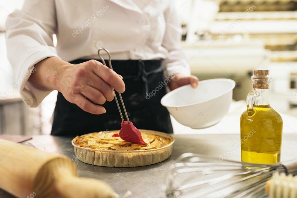Female Pastry Chef Decorating Dessert In The Kitchen Stock