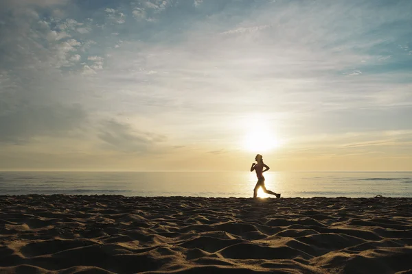 Mujer corriendo en la playa. — Foto de Stock