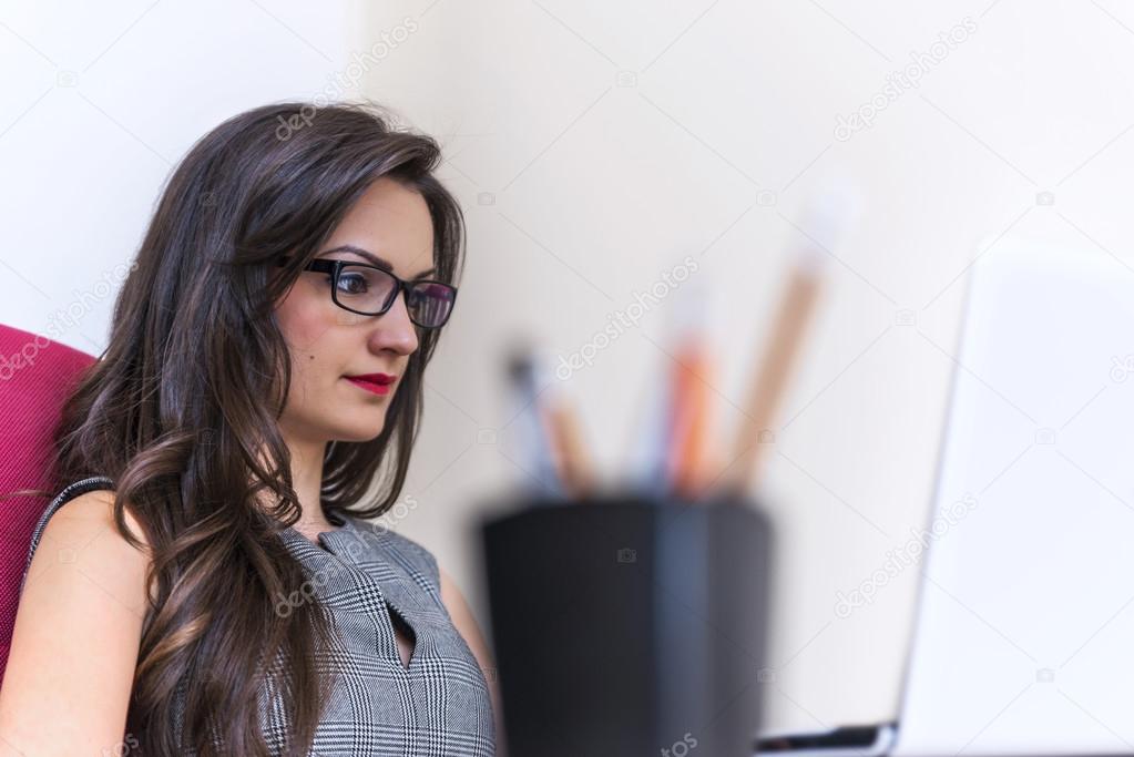 Pretty business woman working at her office