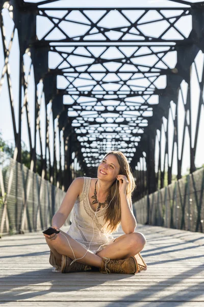 Belle fille avec écouteurs et téléphone portable — Photo