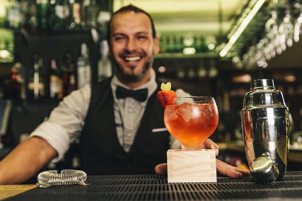 Barman is making cocktail at night club
