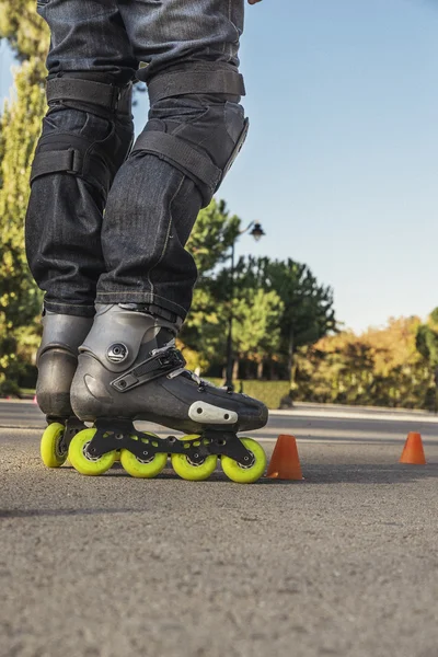 Gros plan des jambes en patin à roulettes sur la route de l'arrière — Photo