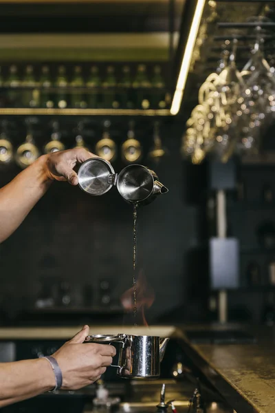 Barman is making cocktail at night club