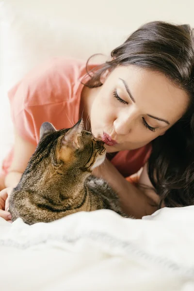 Happy woman kissing her cat. — Stock Photo, Image