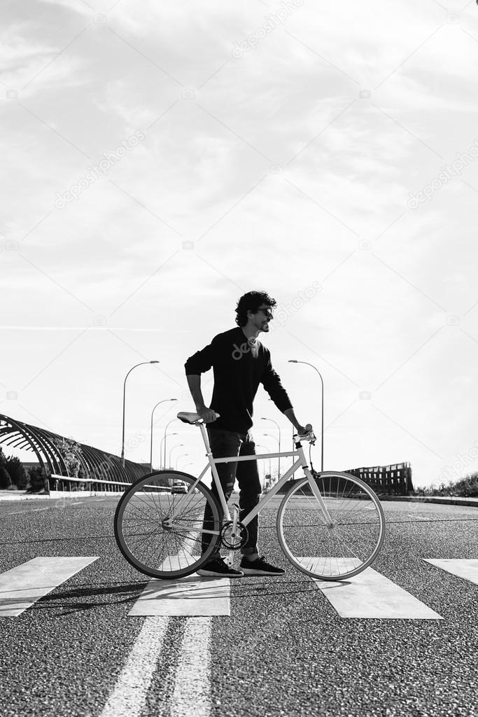 Handsome young man with fixed gear bicycle.