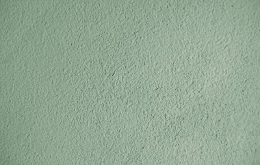 Açık yeşil duvardaki soyut kumlu doku. Tasarım ögesi ve arkaplan olarak kullanılabilir