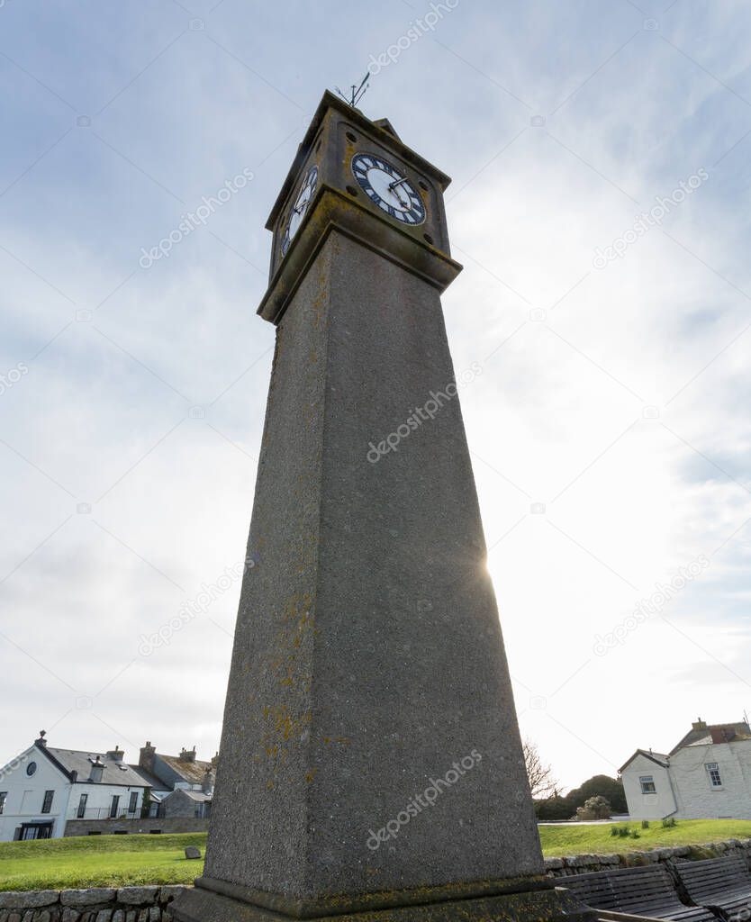 bottom view of Cape Cornwall tower clock on sunset