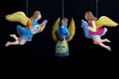 İpli melekler, karanlık arka planda izole edilmiş güzel Noel süslemeleri.