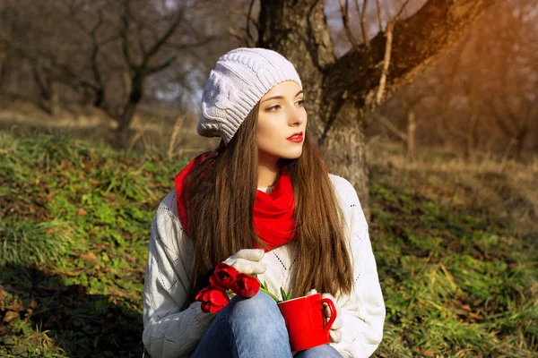 Spring portrait of a girl with red tulips — Stock Photo, Image