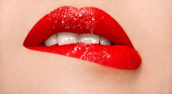 Woman's red lips coated with scattered sugar — Stock Photo, Image