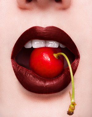 Sexy bite! A closeupcherry in her mouth. clipart