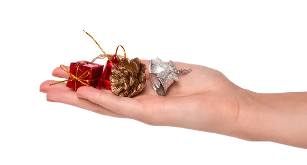 Рука с рождественскими игрушками на белом фоне Стоковое Фото