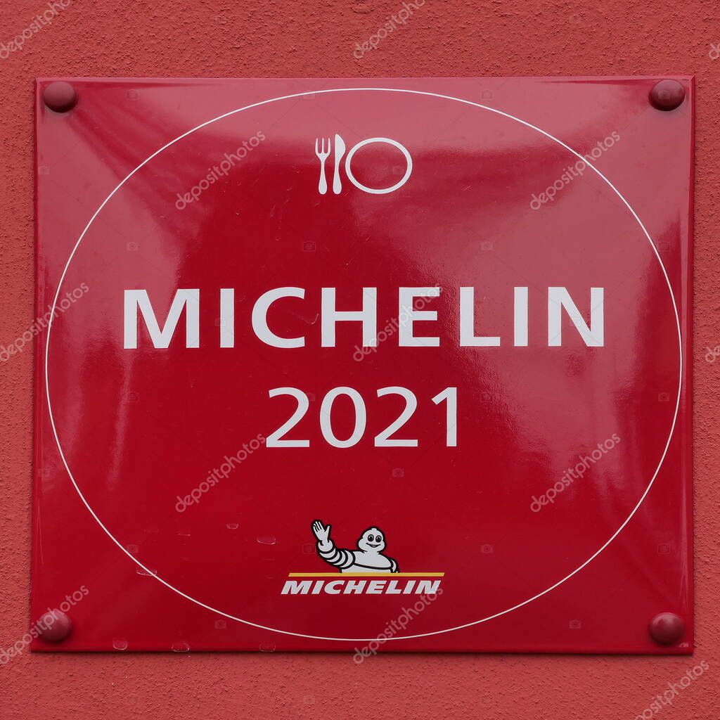 Michelin restaurant symbol on a wall. Michelin guides are a series of guide books published by the Michelin for more than a century