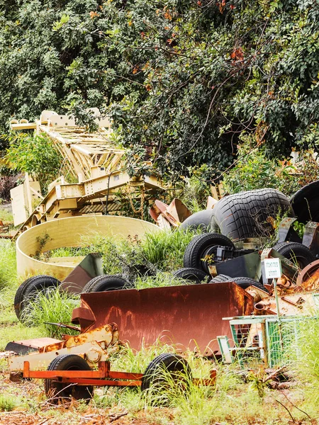 Environmental pollution.Thrown in the forest part of the old, worn-out farm machinery Stock Photo