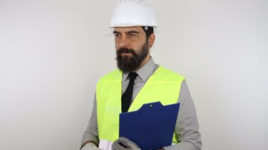 Sakallı miğfer takan, ters tahtayı tutan ve parmaklarını sağa sola gösteren mimar..