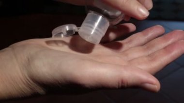 Yakından bakınca, kadınların elleri ellerini temizlemek için jel kullanıyor.