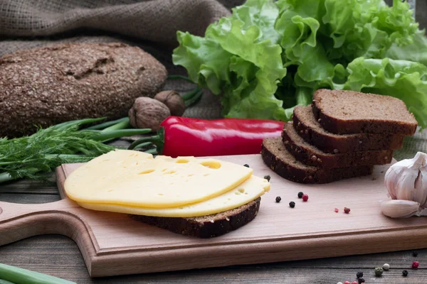 Cheese and bread on the table and  fresh herbs Stock Image