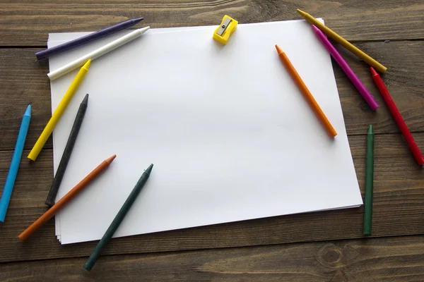 Colored pencils and a sheet of paper — Stock Photo, Image