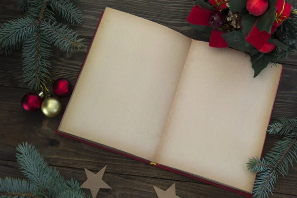 Red Christmas decorations and an open book — Stock Photo, Image