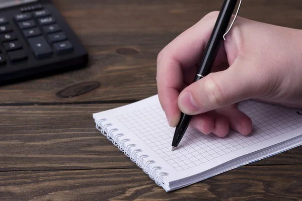 The man's hand writing with a ballpoint pen — Stock Photo, Image