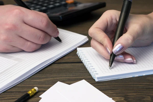 People do write in the notebook handles , telephone — Stock Photo, Image