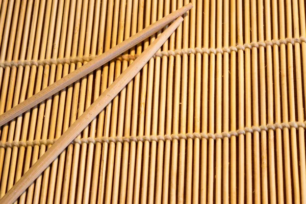 Bamboo mat and chopsticks food background — Stock Photo, Image