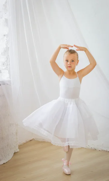 Cute shy little ballerina posing in classical tutu — Stock Photo, Image