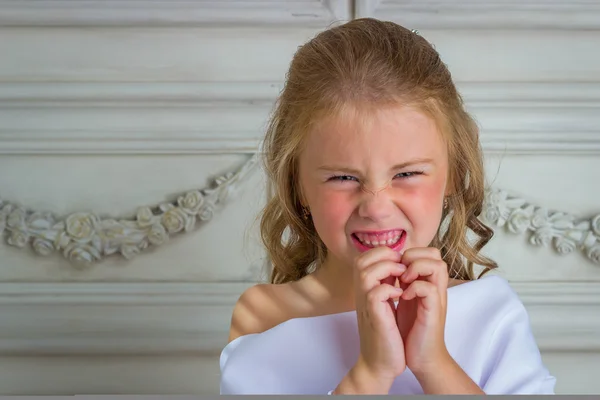 Evil emotion and smile, little beautiful angel in white robe — Stock Photo, Image