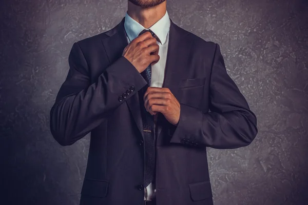 Brutal sexy businessmen in suit with tie standing near the wall. Boss concept. — Stock Photo, Image