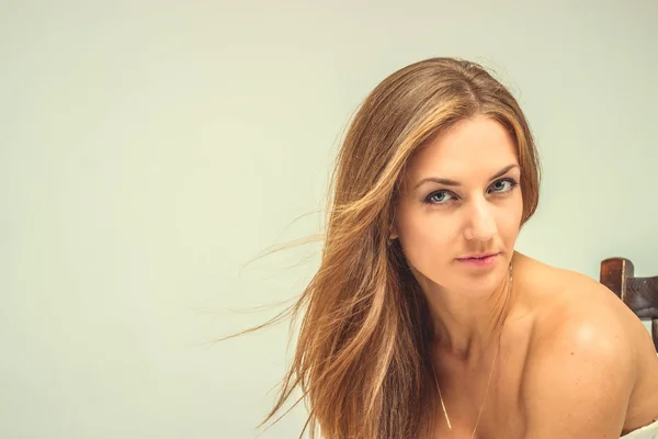 Beautiful sexy girl in white dress sit on chair, isolated — Stock Photo, Image