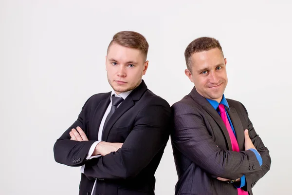 Two business men standing back to back, isolated Stock Image