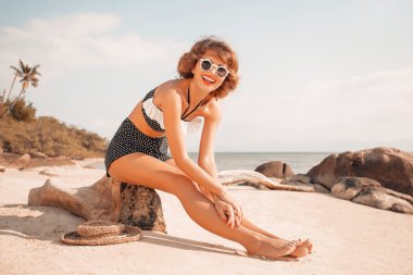 attractive young woman in bikini on the beach clipart