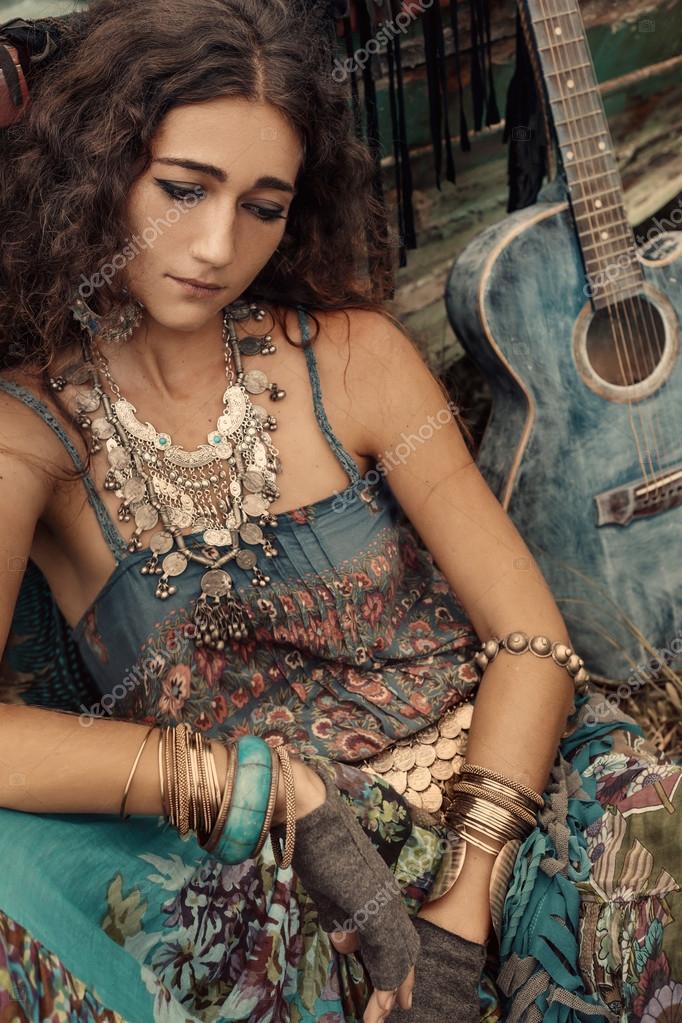 Atrractive young hippie woman with guitar outdoors Stock Photo by  ©Zolotareva123 122143072