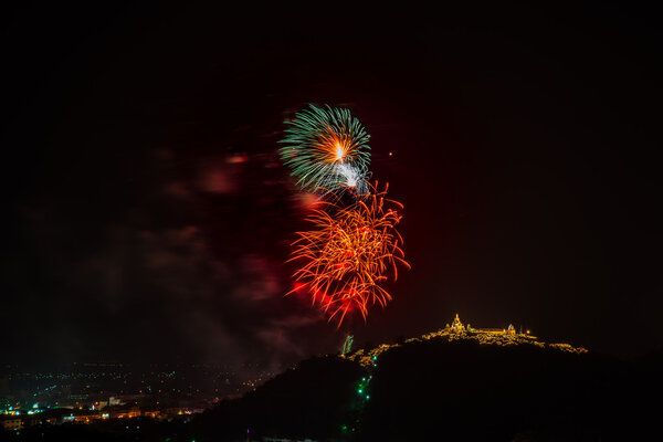 Fireworks at Kao Wang mountain, over the cityscape of Petchburi, Thailand