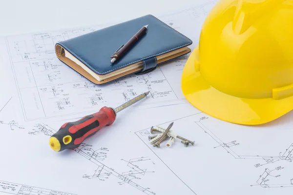 Yellow safety helmet, notebook and screwdriver — Stock Photo, Image