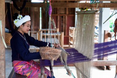 Geleneksel Tai Lue elbisesi içindeki Asyalı kadın (Kuzey Tayland kültürü) eski ahşap makine, etnik çalışma, Nan kültürü, Tayland