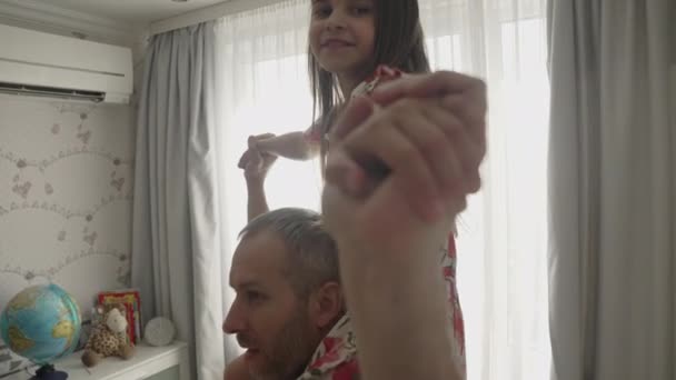 Glimlachende vader het hebben van plezier spinnen dansen met schattig kind — Stockvideo