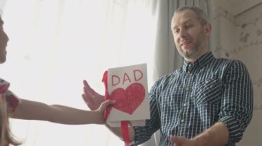 Çocuk, sevgili babası için bir hediye kutusu veriyor.