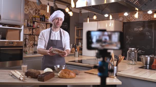 Muž kuchař připravuje jídlo a vlogging v kuchyni on-line — Stock video