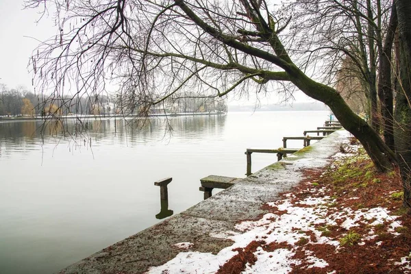 A day after the snow the greatest day to visit Herastrau park. Beautiful landscape with reflections.Moody sky cold day